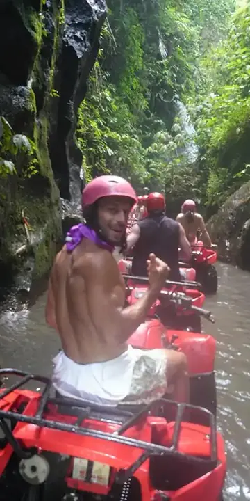 ATV riders heading through a narrow river gorge on the SYB Bali trip