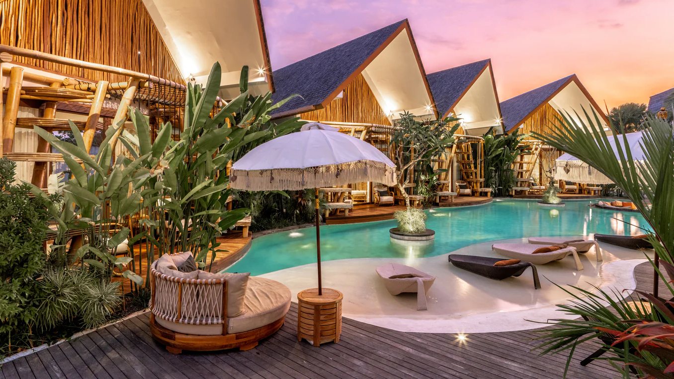 The villa pool and the bamboo bungalows at dusk