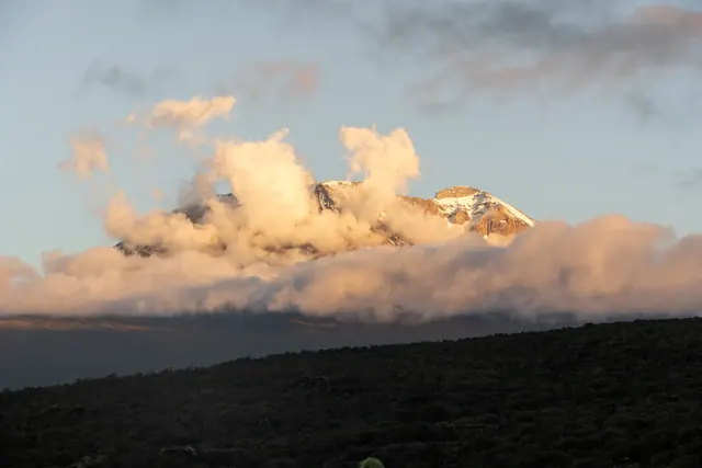Sunset glow lighting up Kibo peak on Mount Kilimanjaro with Hardest Adventures.