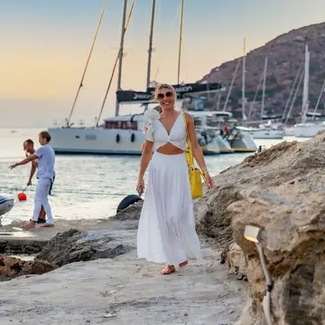 Coming ashore from the boats dressed in white at golden hour on the SYB Greece trip
