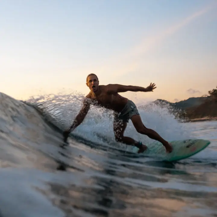 Surfer riding a wave, shot from the water on the SYB Nicaragua Surf Camp trip