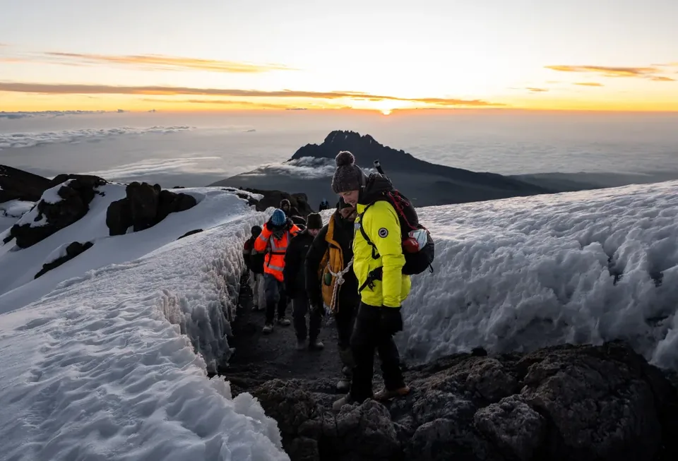 Hikers coming down from Uhuru Peak at sunrise, Kilimanjaro