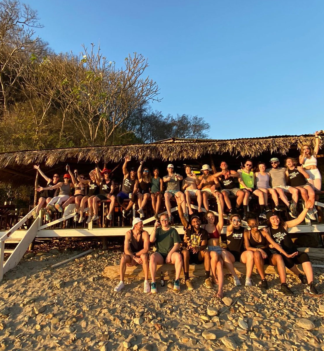 A big SYB group in swimwear in front of a thatched beach hut in Nicaragua