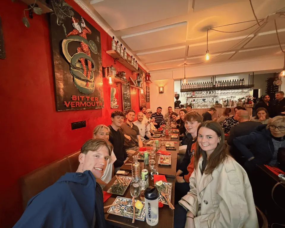 Group of participants eating a big carb loading dinner in preparation for their marathon with Hardest Adventures.