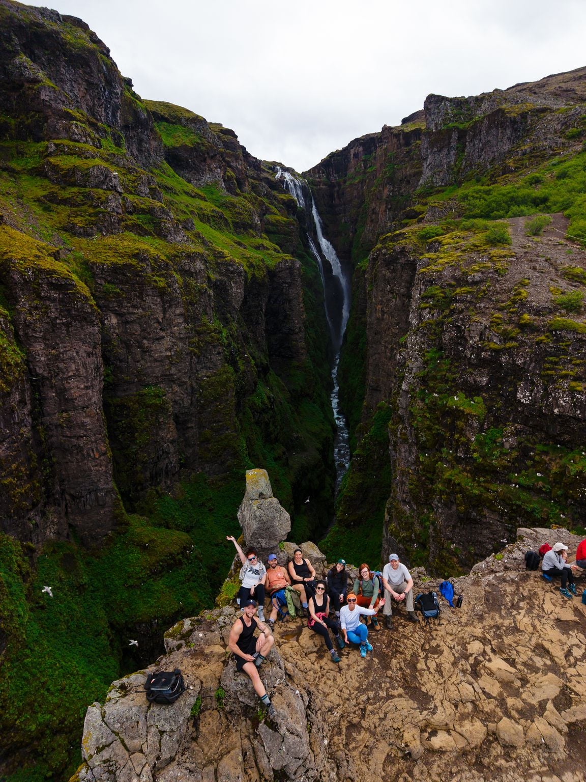 The SurfYogaBeer crew on the cliff edge above Glymur waterfall