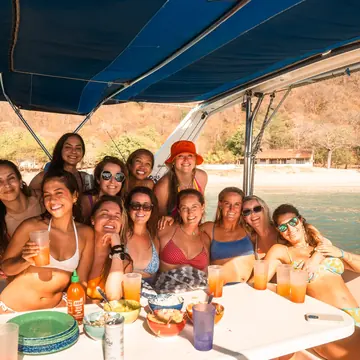 The whole crew around the table on the boat