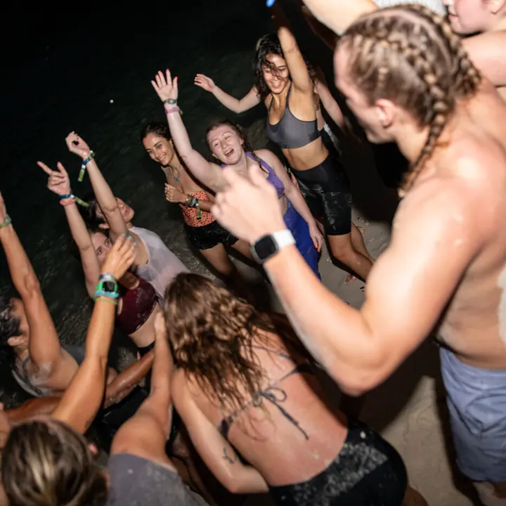 Dancing with hands in the air at night on the SYB Philippines trip