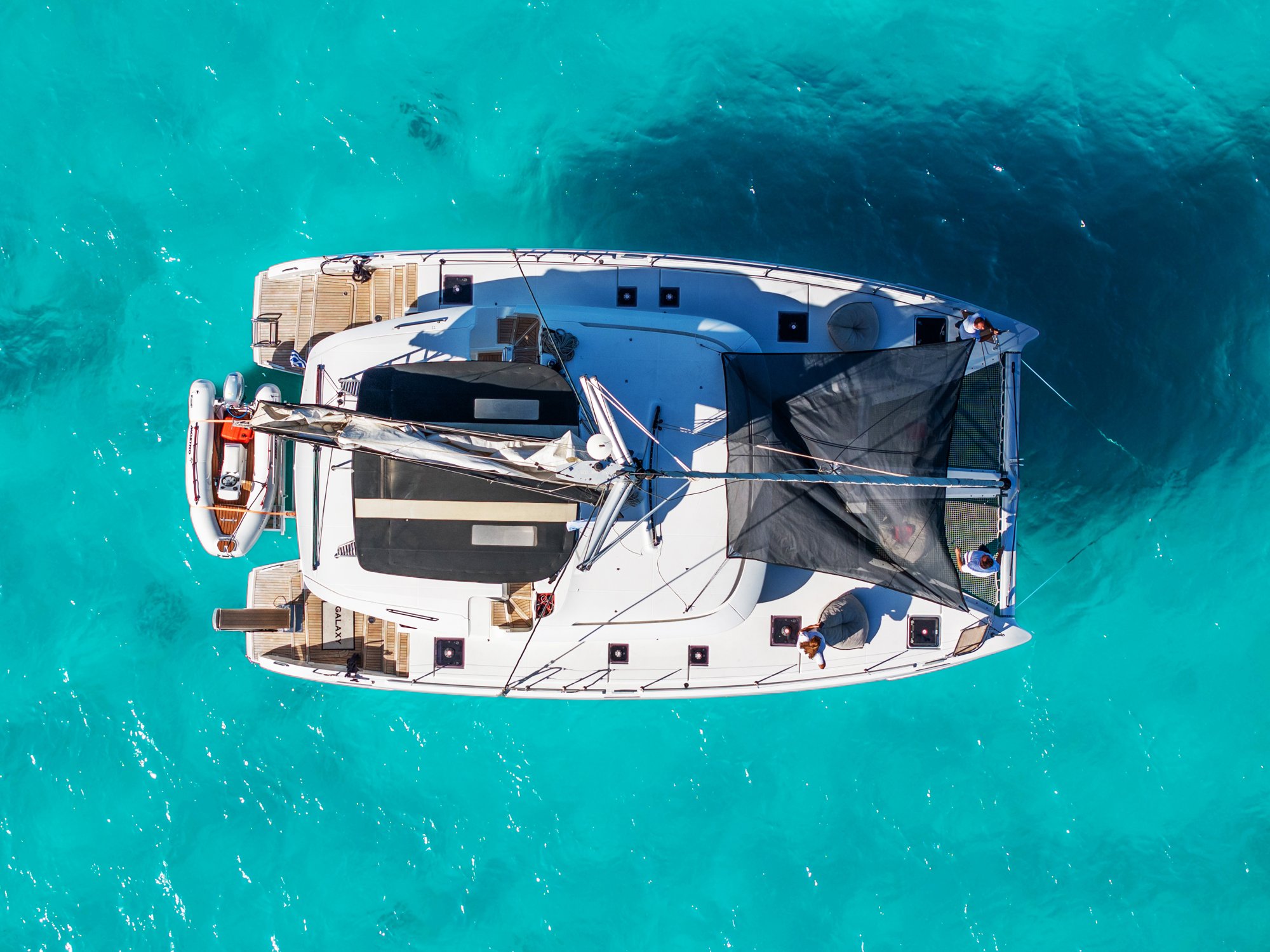 Galaxy, one of our Lagoon 46 catamarans, from above in turquoise water
