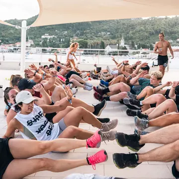 Group doing sit ups together on a shaded terrace on the SYB Croatia trip