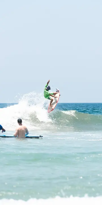 Surfer hitting the top of a wave in Nicaragua