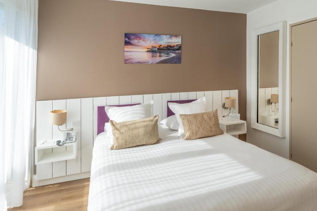 A bright room with the bed made up