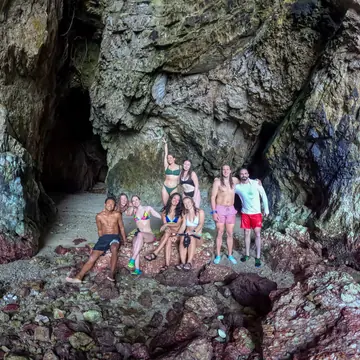 Group posing inside a sea cave on the SYB Philippines trip