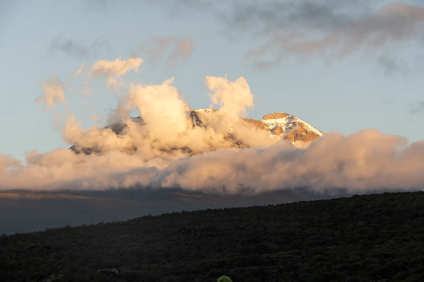 Sunset glow lighting up Kibo peak on Mount Kilimanjaro with Hardest Adventures.