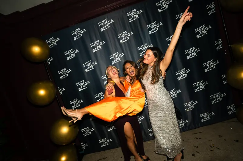 Friends kicking up a leg at the photo wall
