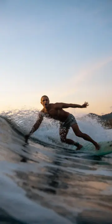 Surfer carving a wave at dusk on the SYB Nicaragua trip