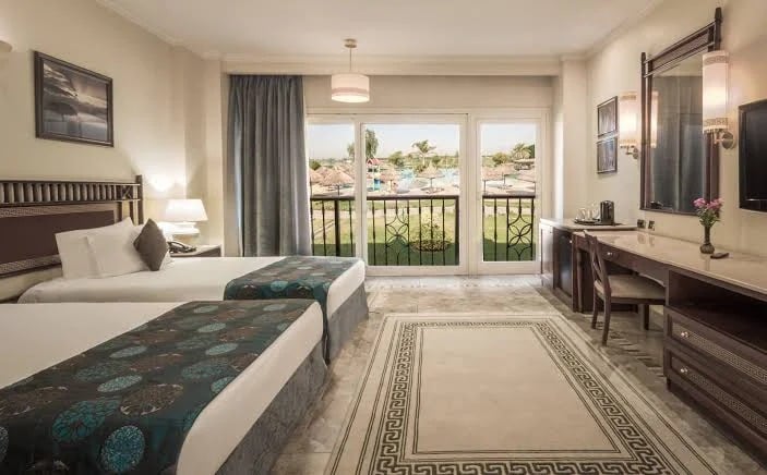 A Jolie Ville twin room with two beds and a balcony