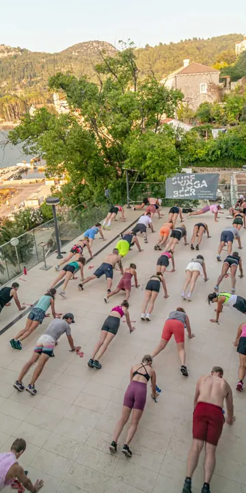Group workout seen from above on a terrace by the sea on the SYB Croatia trip