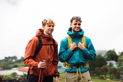 Two trekkers in waterproofs above the Dudh Koshi valley on the first miles out of Lukla
