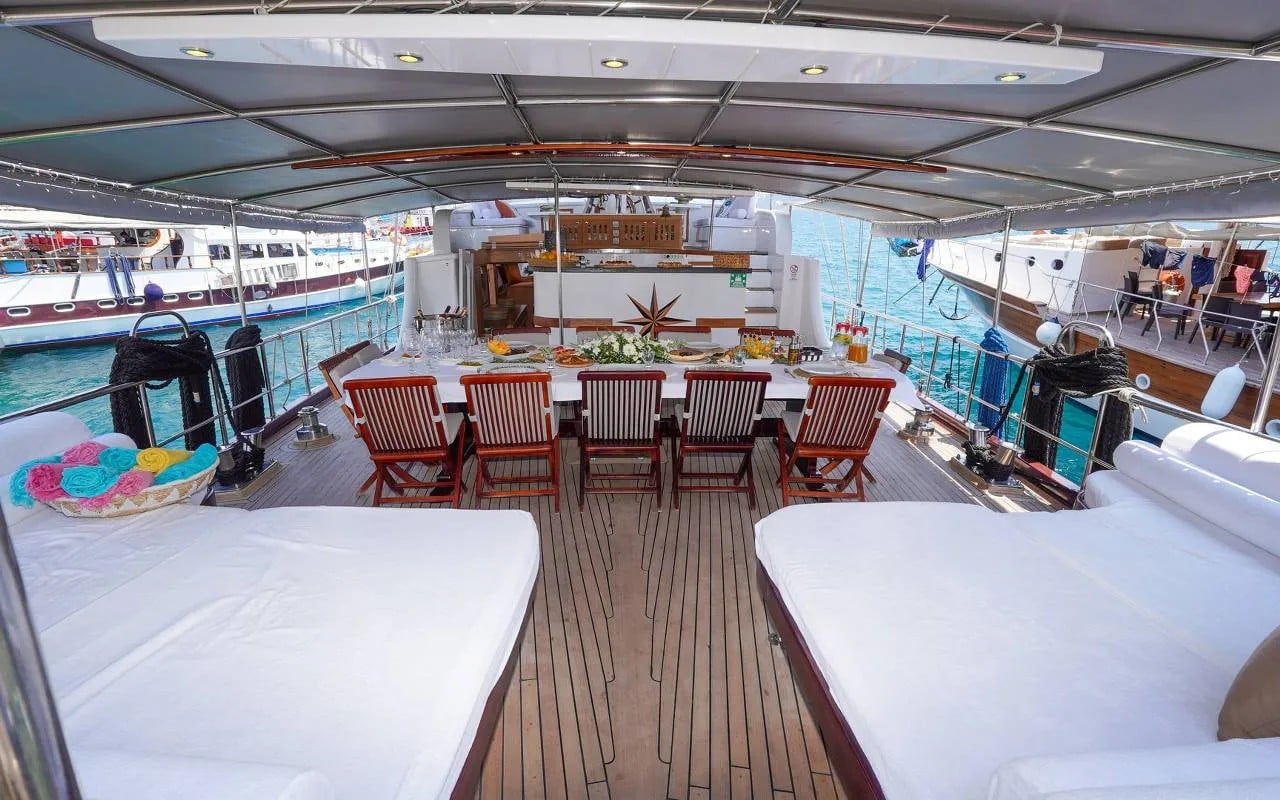 The shaded deck with daybeds and the dining table