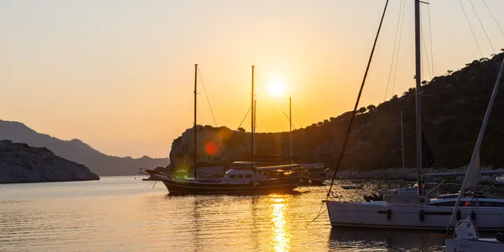 Sunset behind a gulet anchored in a calm bay on the SYB Turkey trip