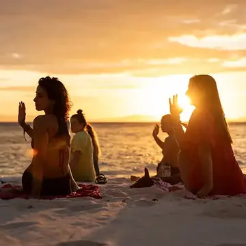 Sitting on the beach in the golden light as the sun goes down on the SYB Philippines trip