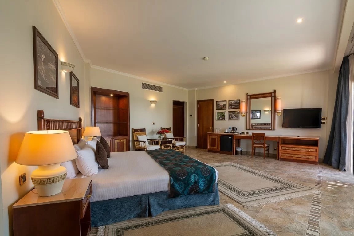 A Jolie Ville suite with a king bed and a lounge area