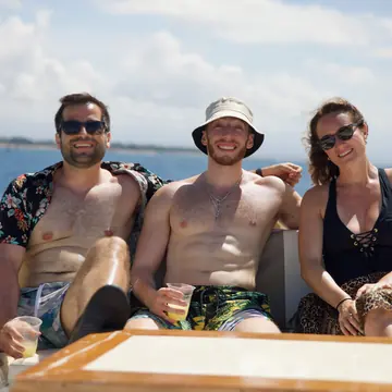 Three friends with drinks on the boat on the SYB Bali trip