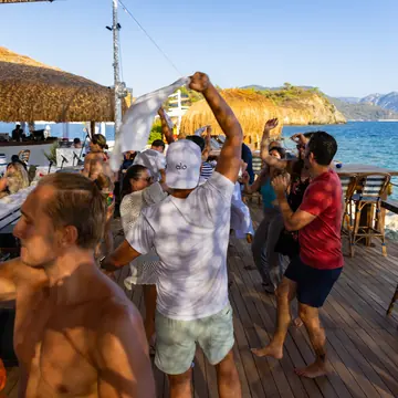Afternoon dance party on the deck of a beach club on the SYB Turkey trip