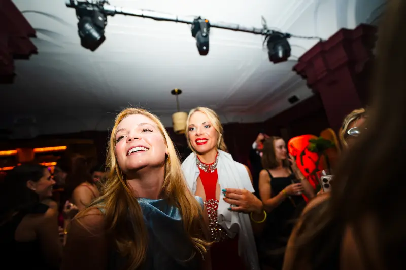 Two friends laughing at the gala