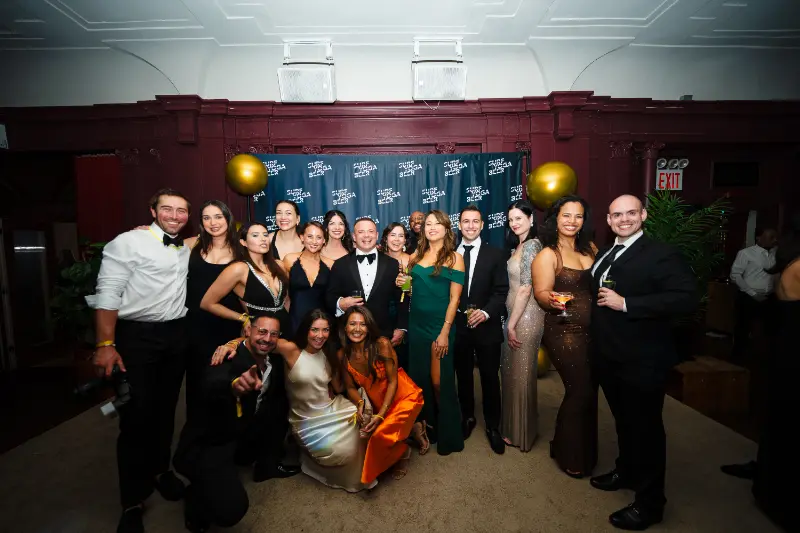 A big group in black tie at the photo wall