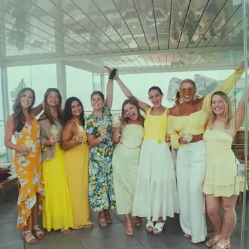 Friends in yellow and white dresses on the terrace on the SYB Amalfi Coast trip