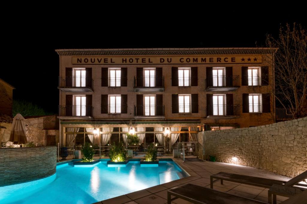The Nouvel Hôtel du Commerce in Castellane lit up at night
