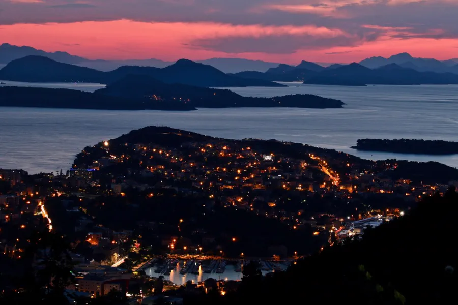 Dubrovnik old town lit up at dusk above the Adriatic, arrival point and awards night on the Dash to Dubrovnik road trip