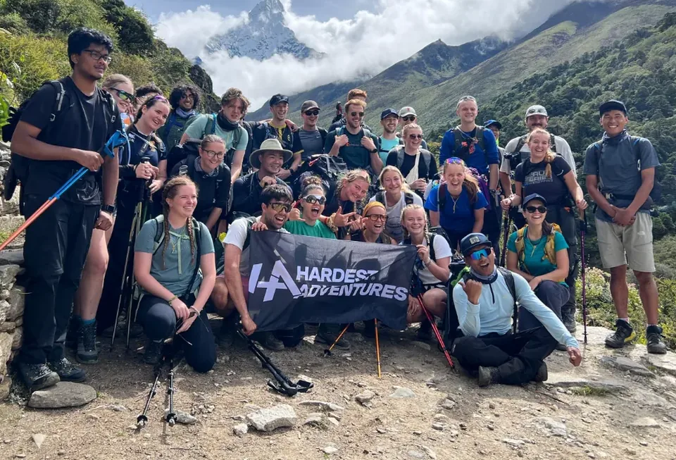 A student group with the Hardest Adventures banner on the Everest Base Camp trail