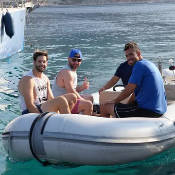 Three friends in the dinghy on clear water on the SYB Turkey trip