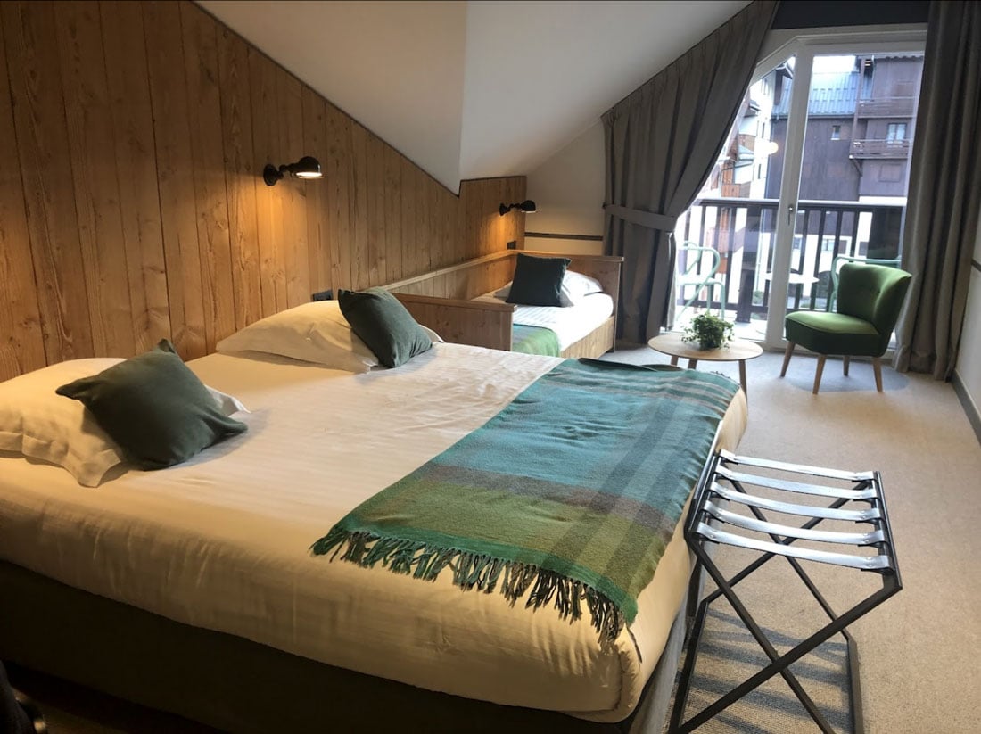 A large private room with a big bed and a balcony at the hotel in Chamonix