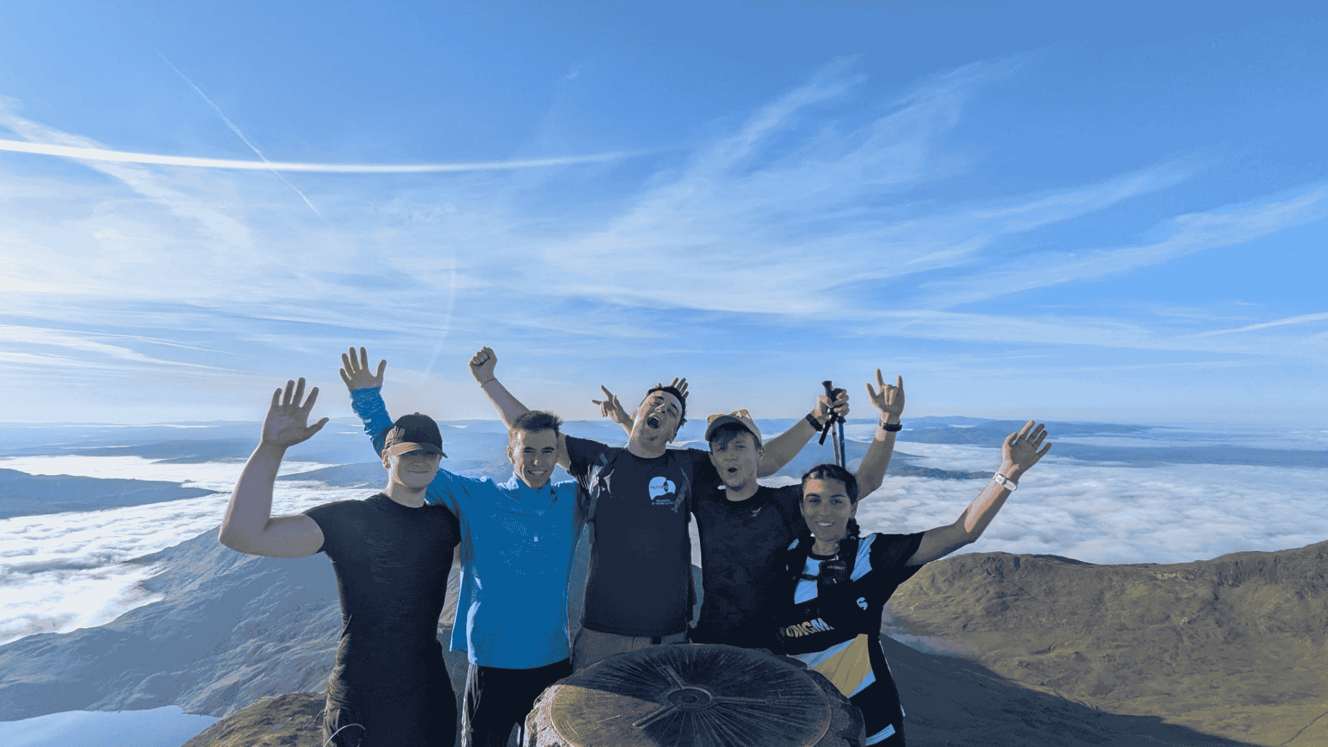 Corporate team celebrating at the summit of Snowdon