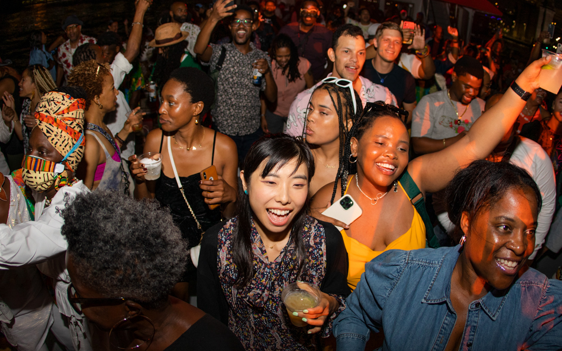 A group of diverse young men and women dancing to house music