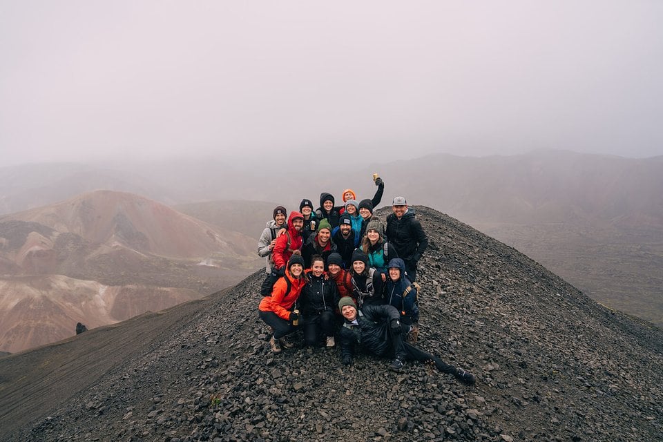 An SYB group on a dark volcanic ridge in the fog in Iceland