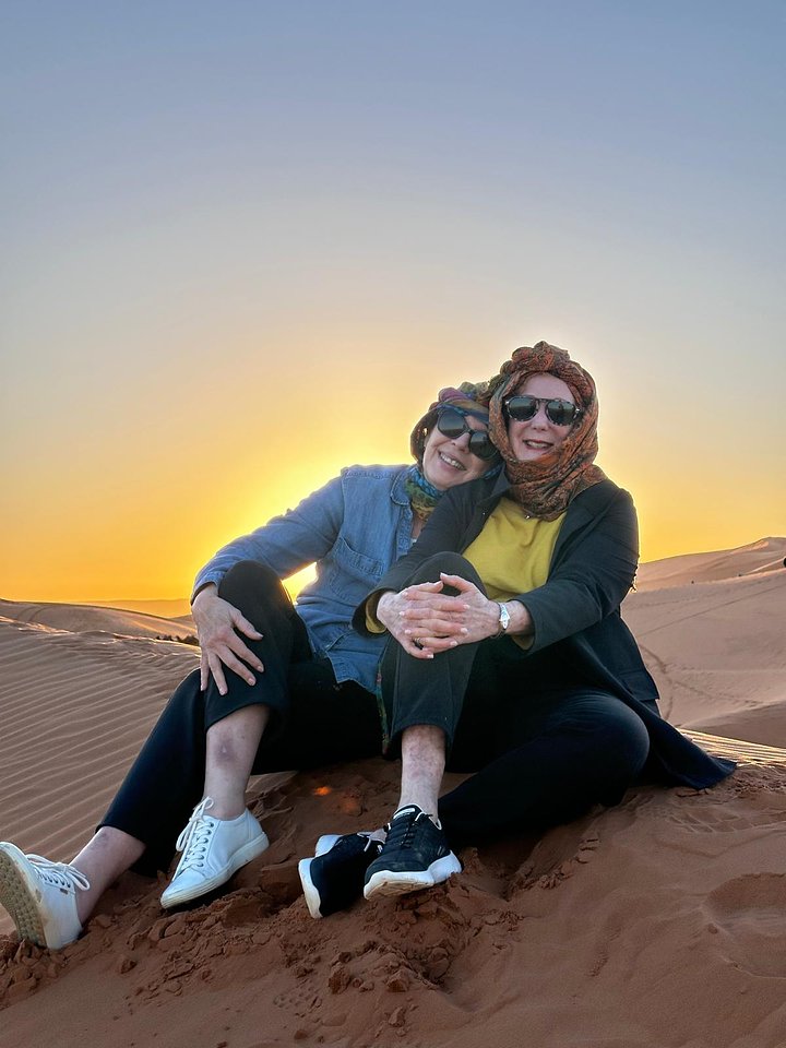 amazingshotoftwowomensittingtogetherindesert