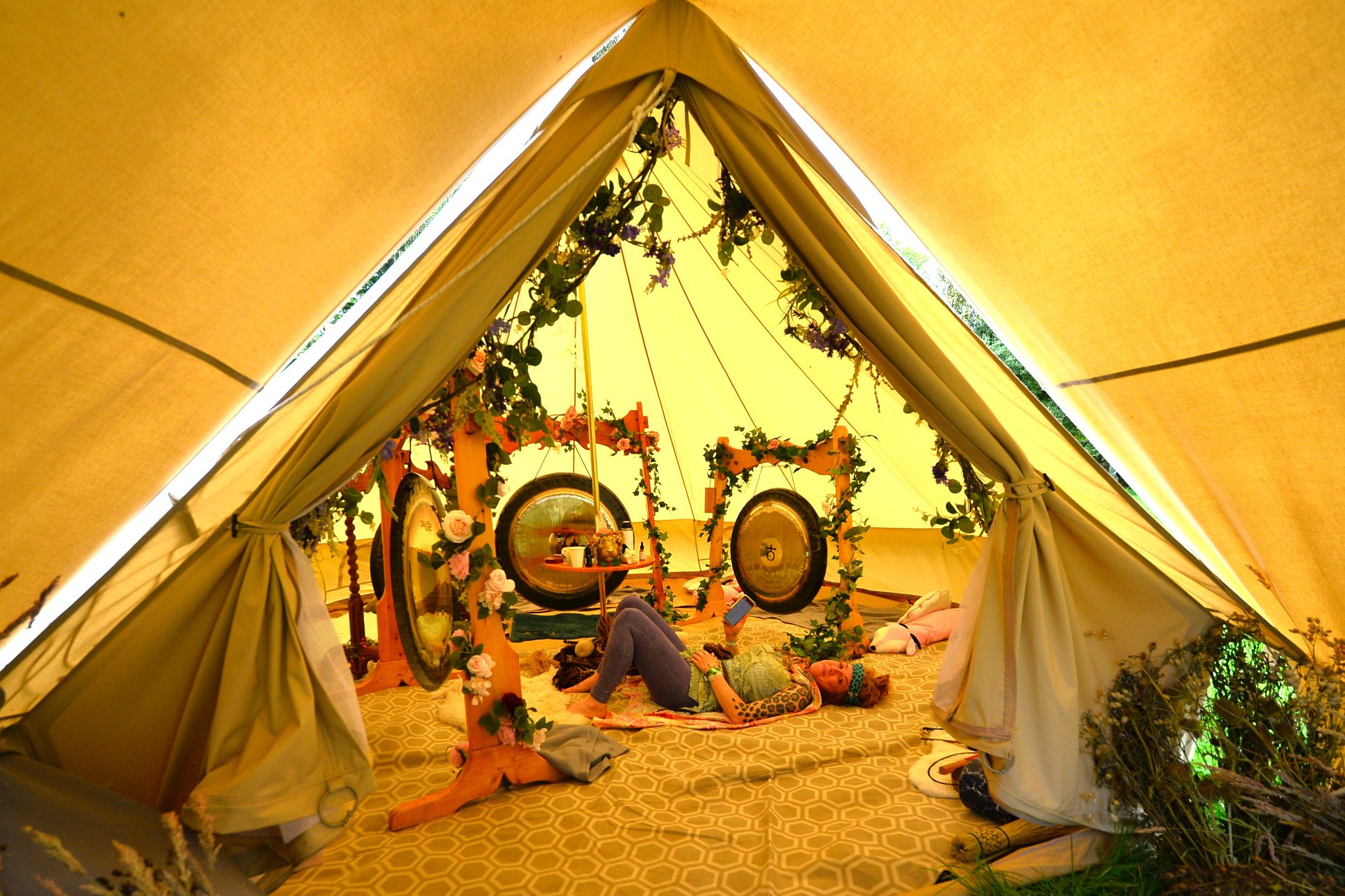 A person lying down getting a gong bath