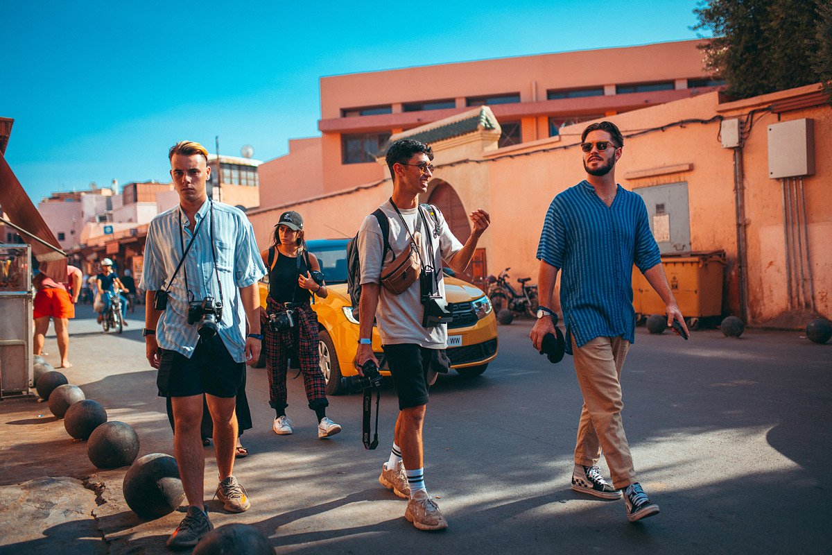 Group of friends walking in the streets of Morocco for Oasis Festival