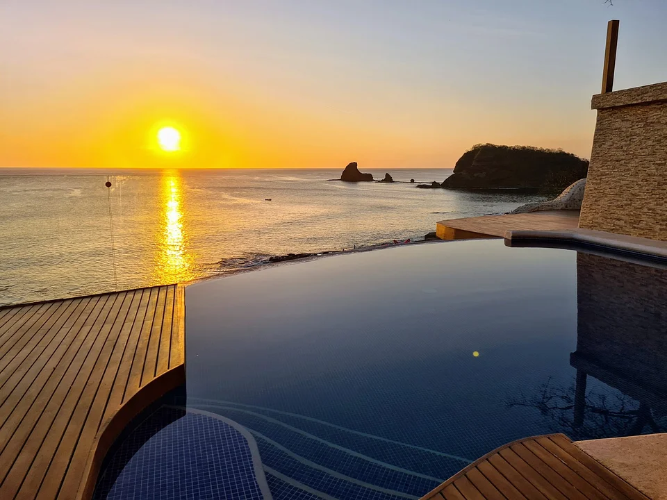Sunset over the Pacific from an infinity pool at Villas Playa Maderas