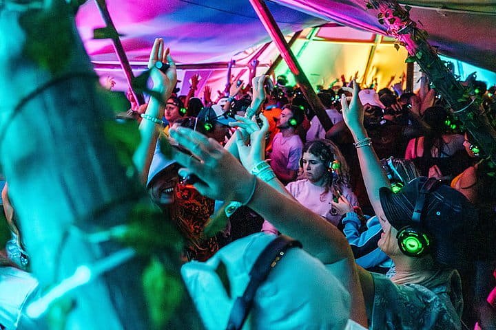 Crowd dance and sing in the Silent Disco arena at Bournemouth 7s Festival in Dorset