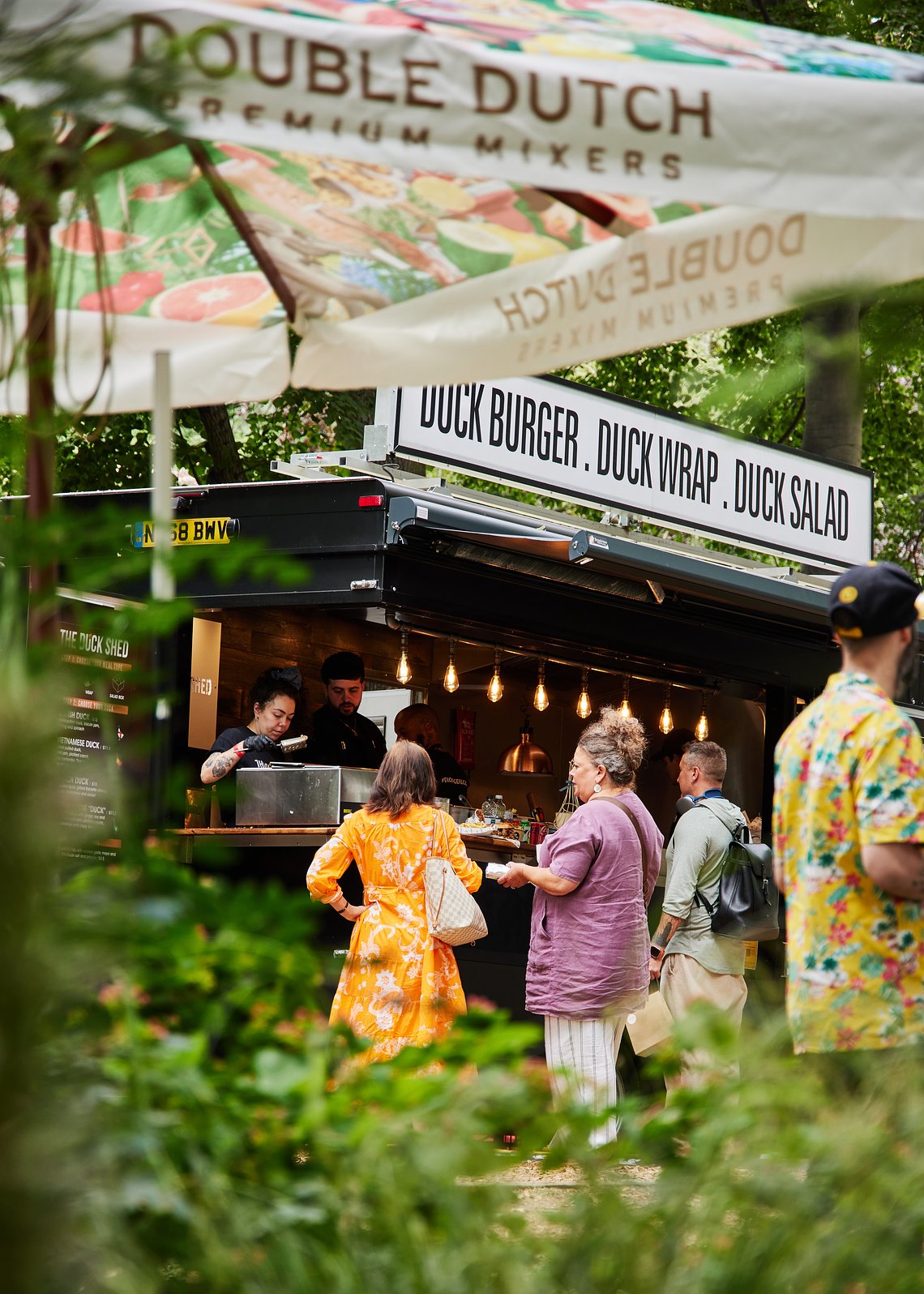 Food vans and independent brands presenting their creations at savour food festival, Delightful Taste Exploration: Festival Attendees Savoring Flavors at Savour Festival