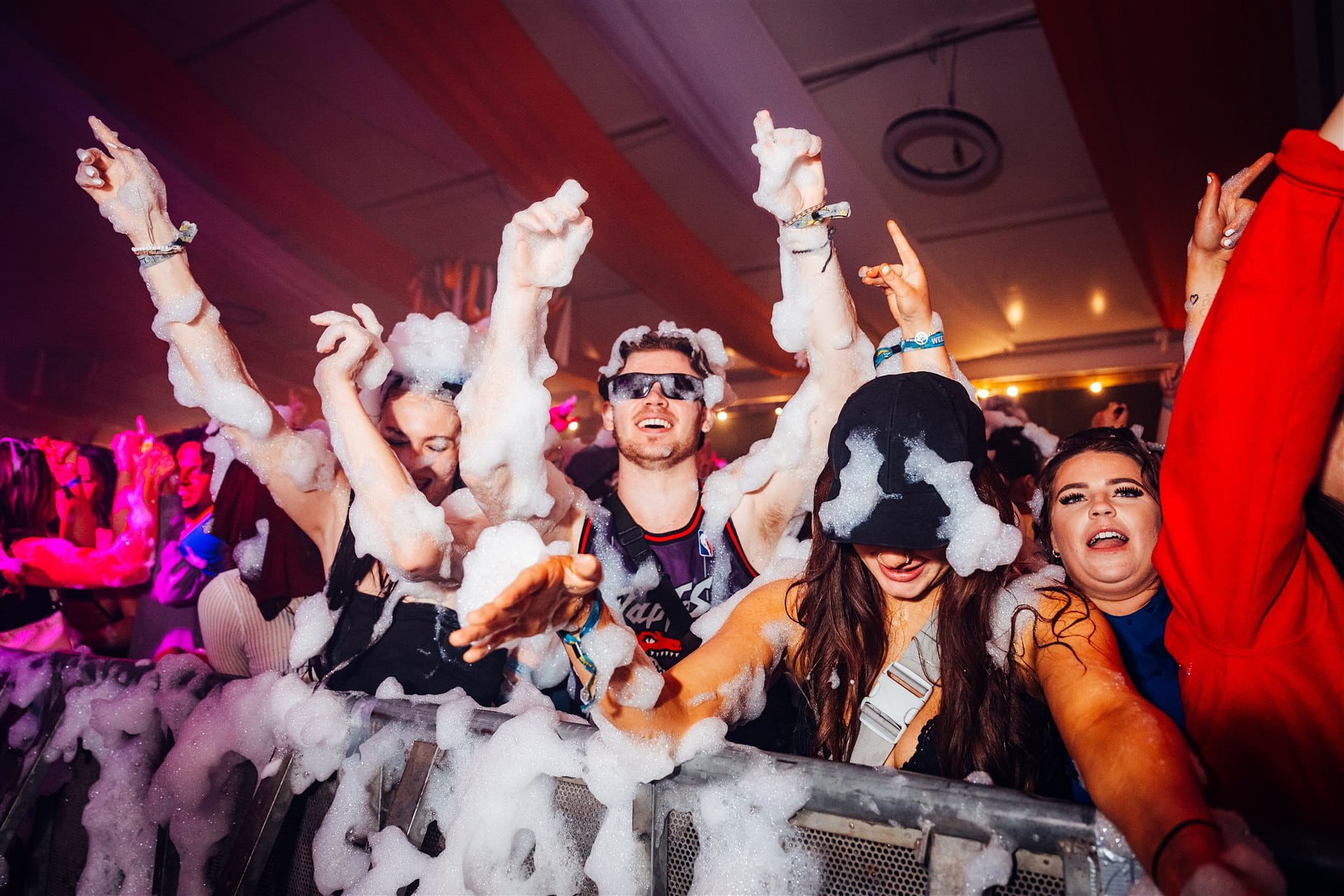 People dance in the foam party during the closing party at Bournemouth 7s Festival in Dorset