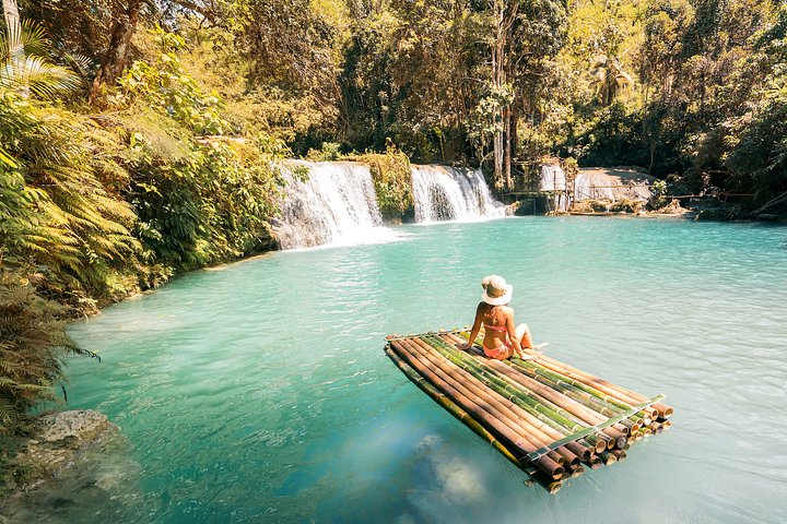 girl sitting on bamboo raft by waterfalls in the jungle cebu philippines weather 