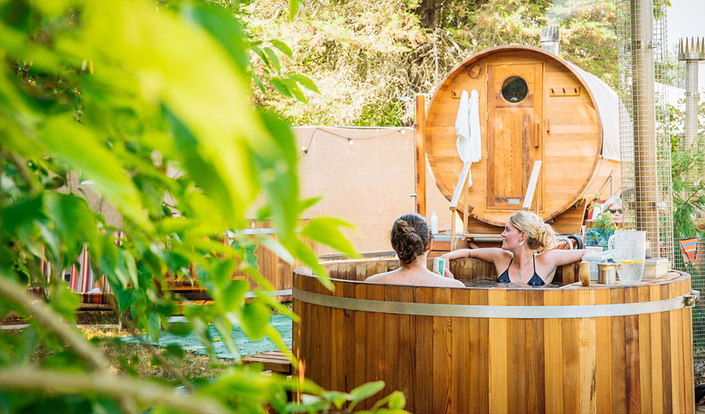 People relaxing in the wooden hot tub in the spa area