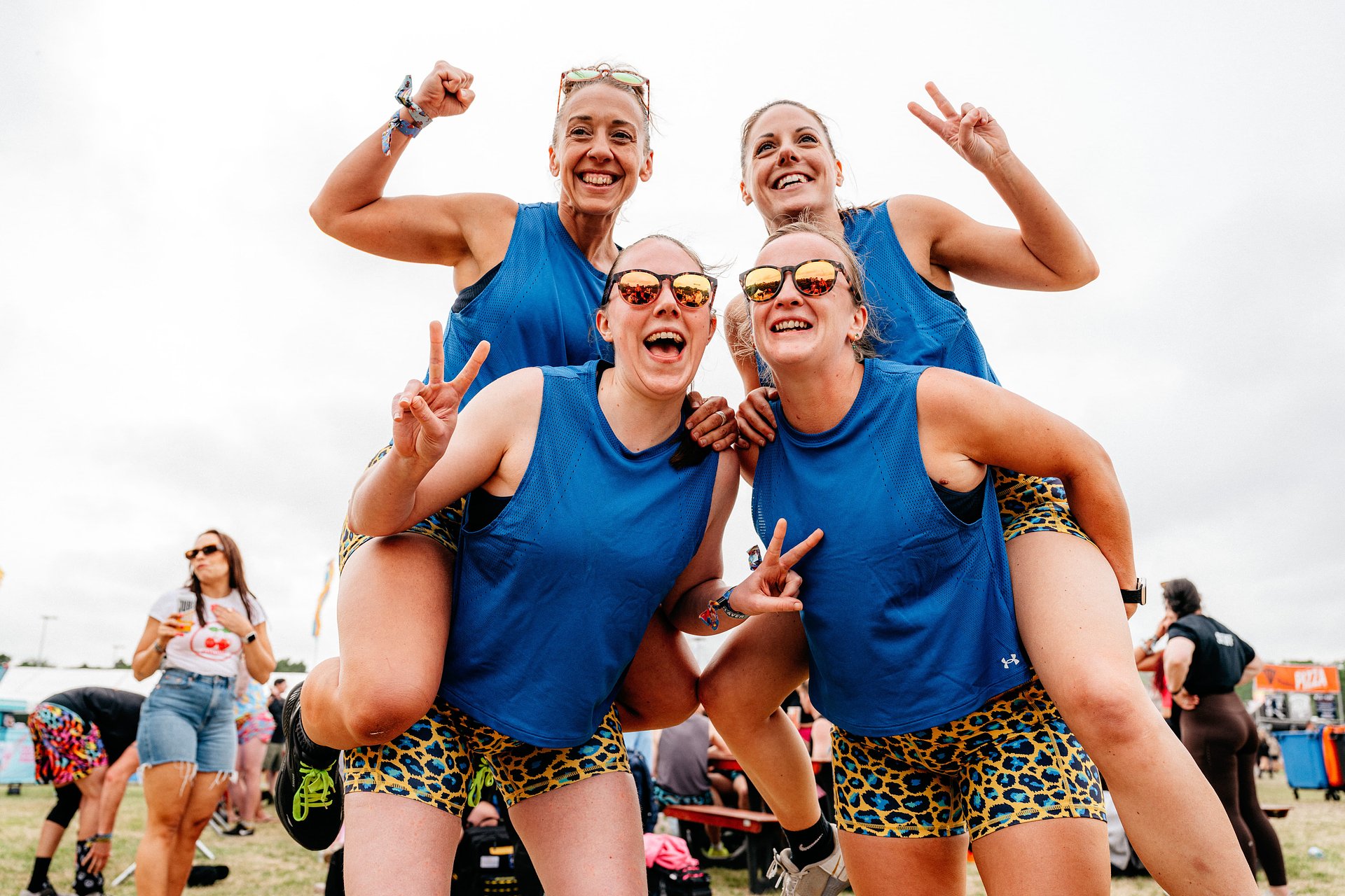 Group of 4 pose after competing in the women's fitness games category at Bournemouth 7s Festival, in Dorset.