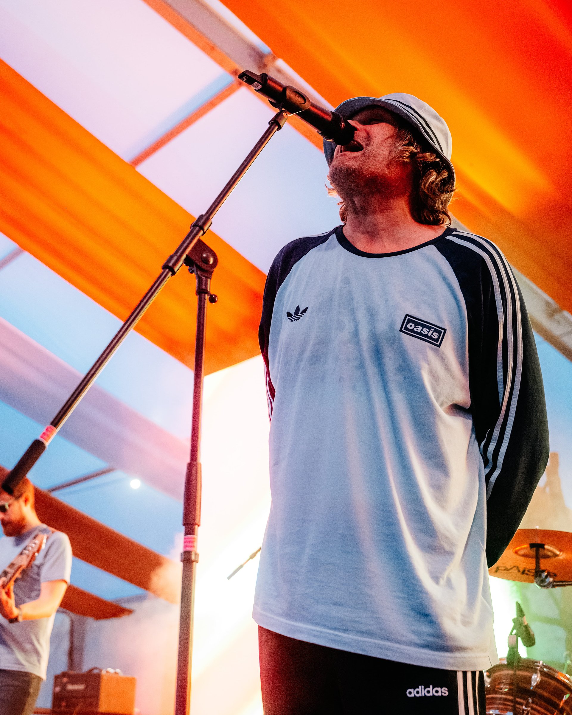 Oasis Tribute Act sings on stage in the Beer Tent at Bournemouth 7s Festival in Dorset